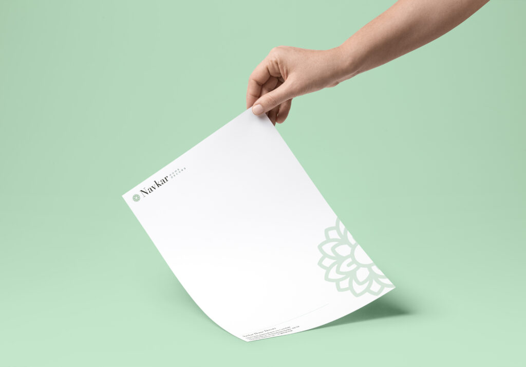 A hand holds a piece of paper against a vibrant green background.